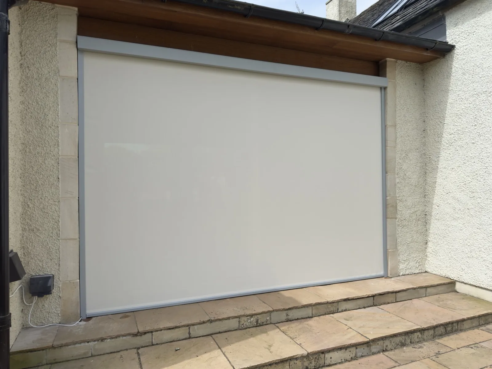 External tensioned zip screens shading a house