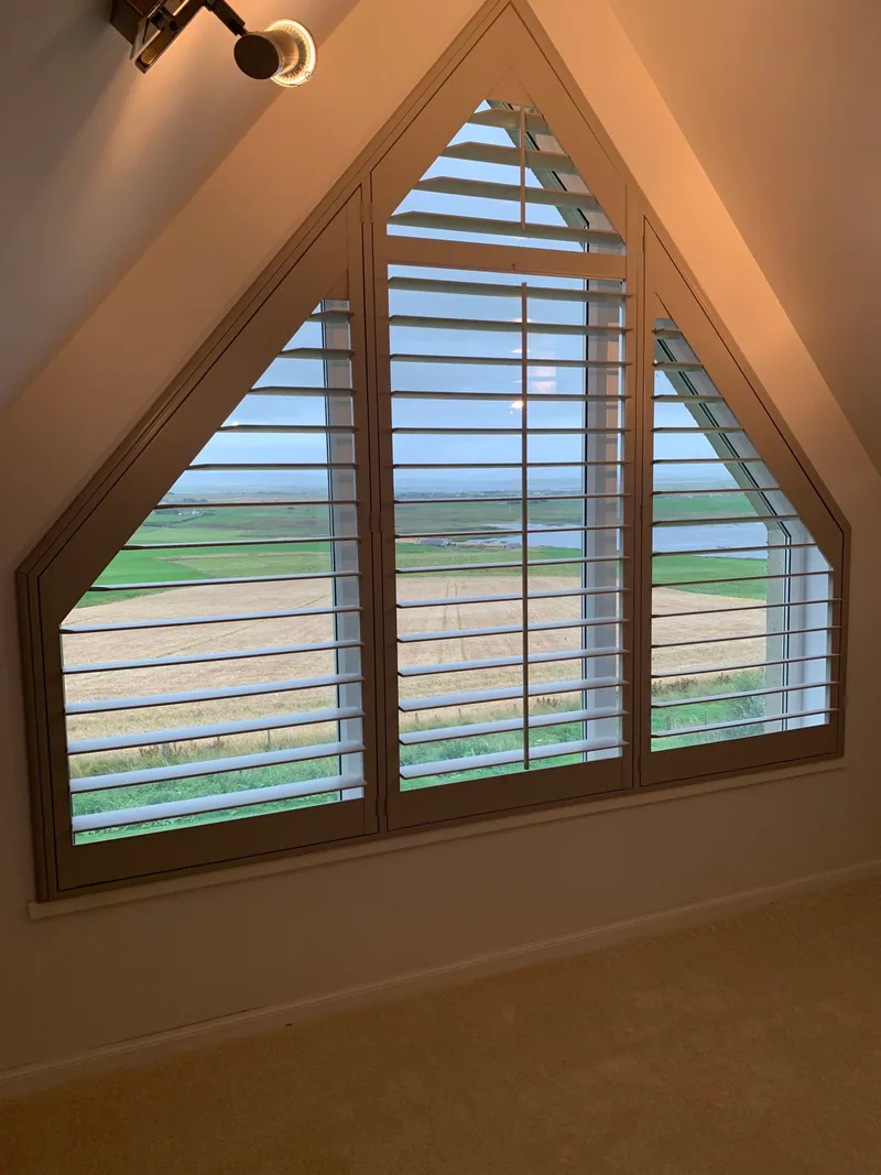 Triangular gable shutters with farmland view in Dounby, Orkney