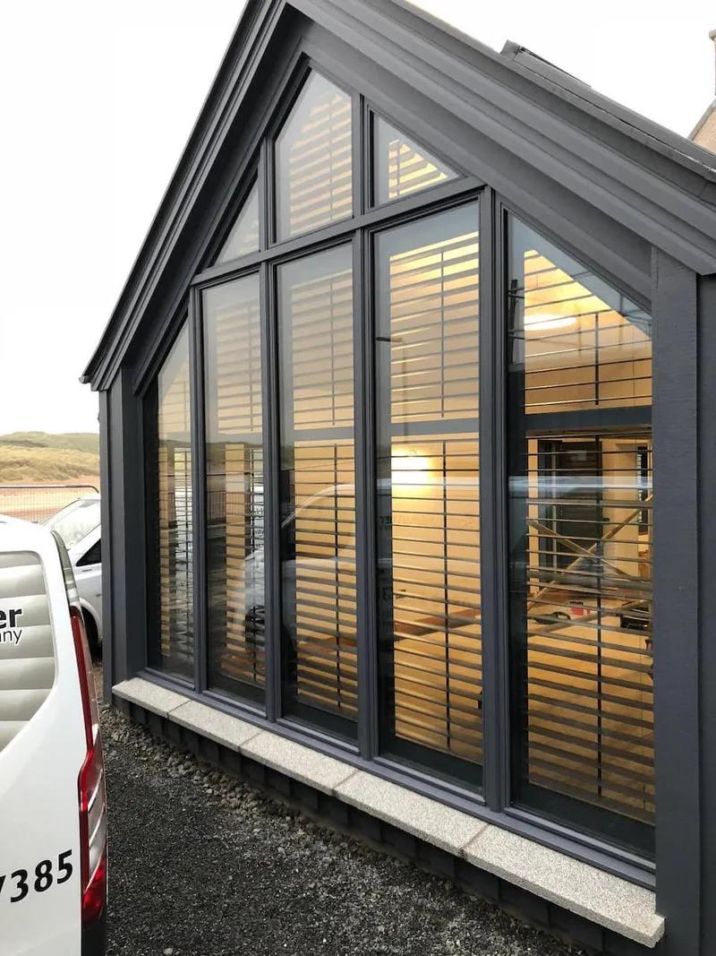 Asymmetric trapezoidal gable shutters fitted to an unusual window shape